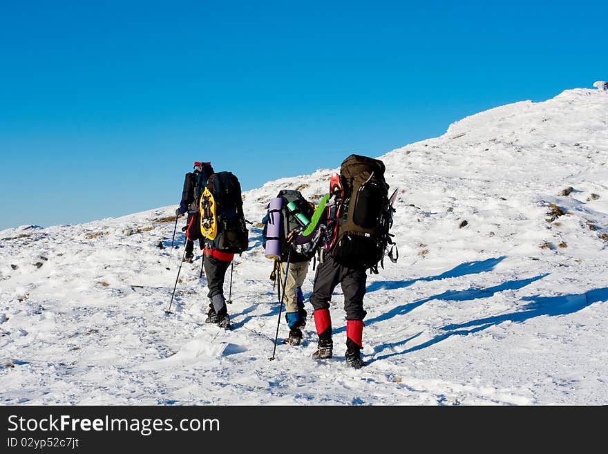 Hiker in winter in mountains