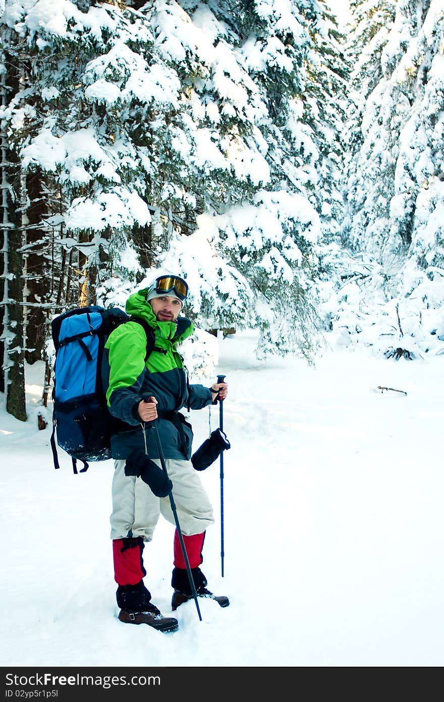 Hiker in winter in mountains