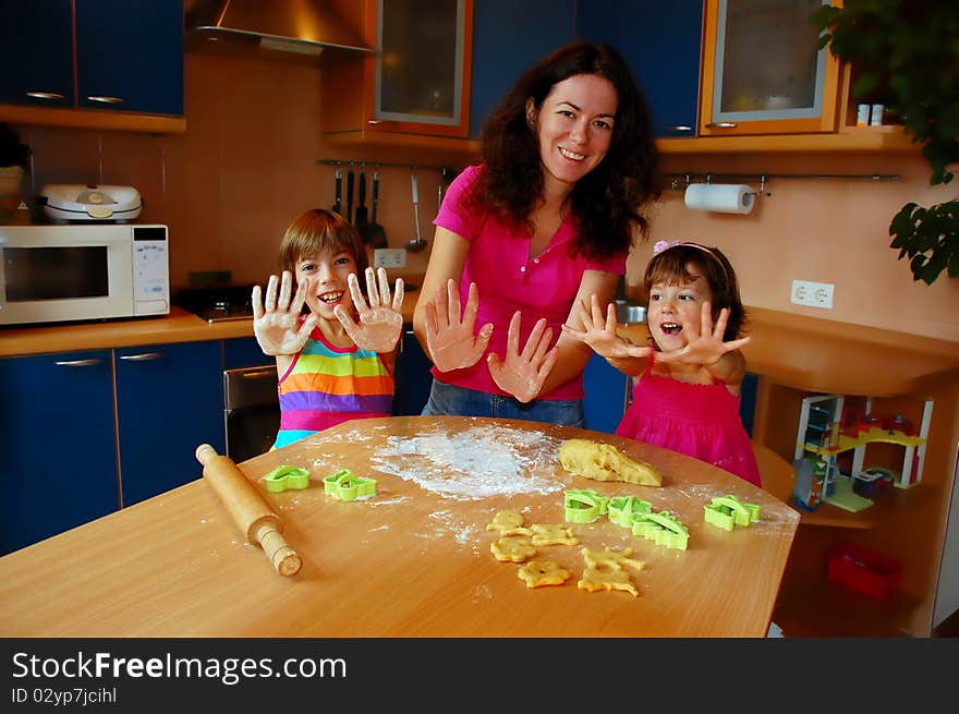 Mother and two daughters baking together. Mother and two daughters baking together