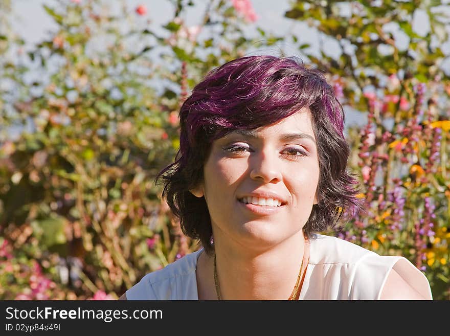 A young woman in a sunlit garden. A young woman in a sunlit garden.