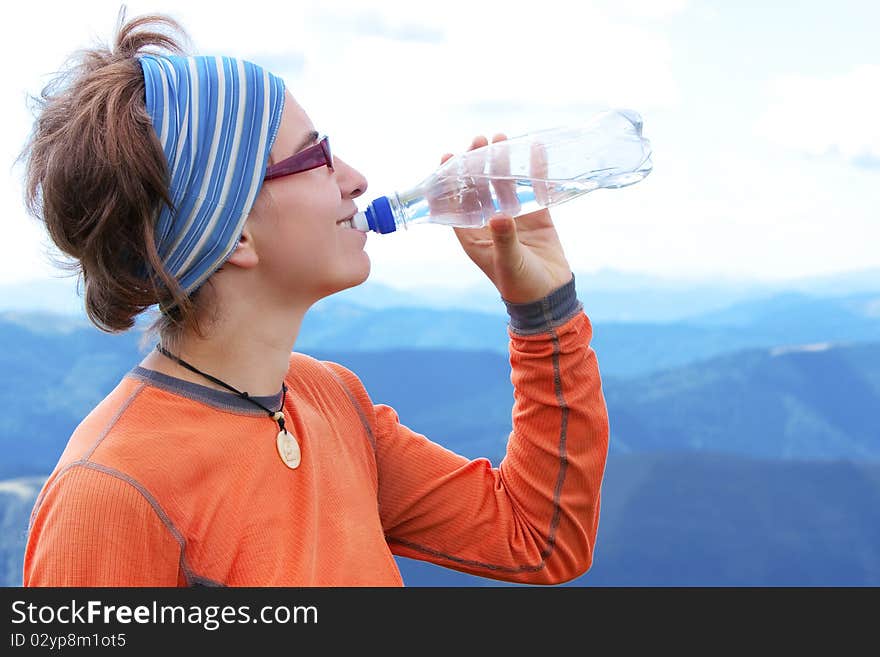 Hiker drinks in Carpathian mountains