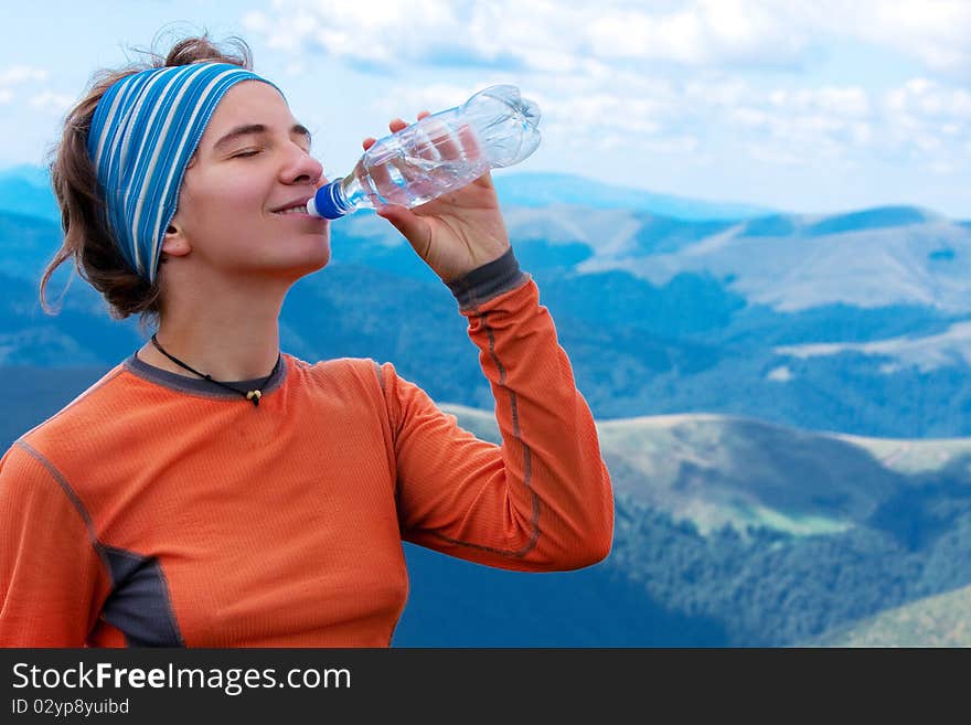 Hiker drinks in Carpathian mountains