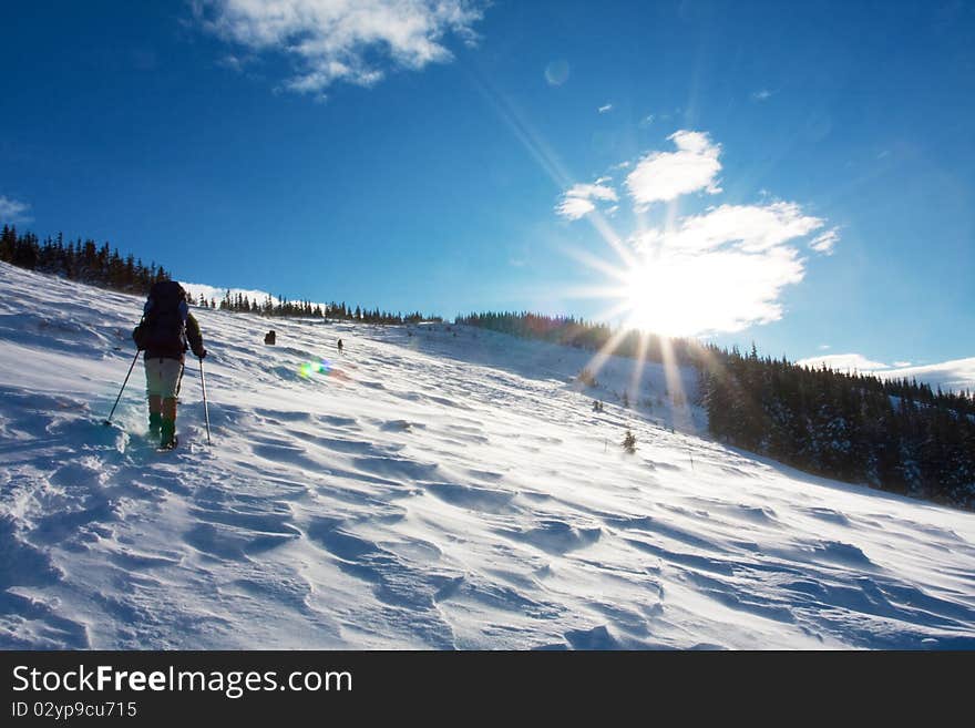 Hiker in winter in mountains