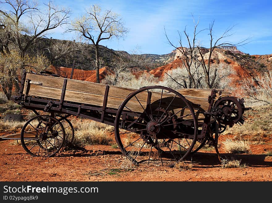 Old Farm equiptment in the desertwith blue sky and clouds in the background. Old Farm equiptment in the desertwith blue sky and clouds in the background