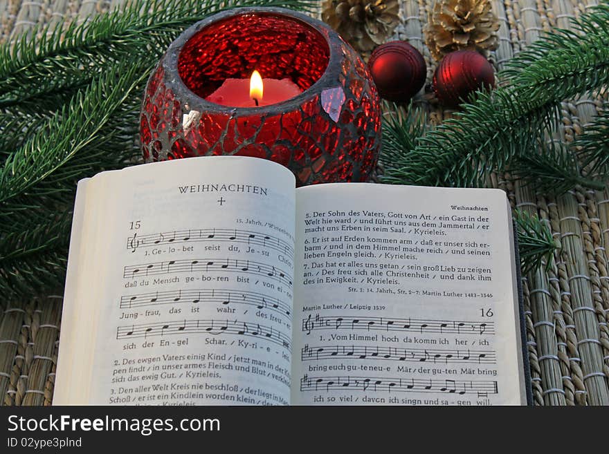 Whipped hymnal in front of a candle. Whipped hymnal in front of a candle