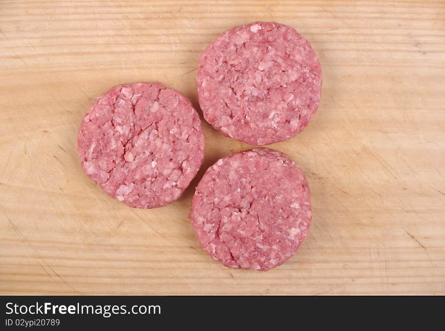 Organic minced meat on wooden chopping board