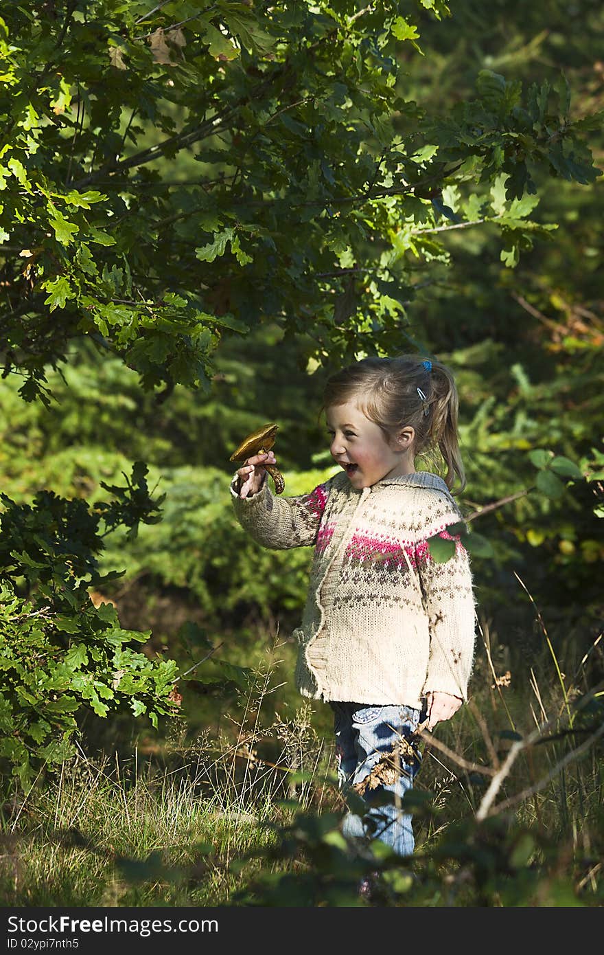 Little girl happy after finding beautiful mushroom. Little girl happy after finding beautiful mushroom