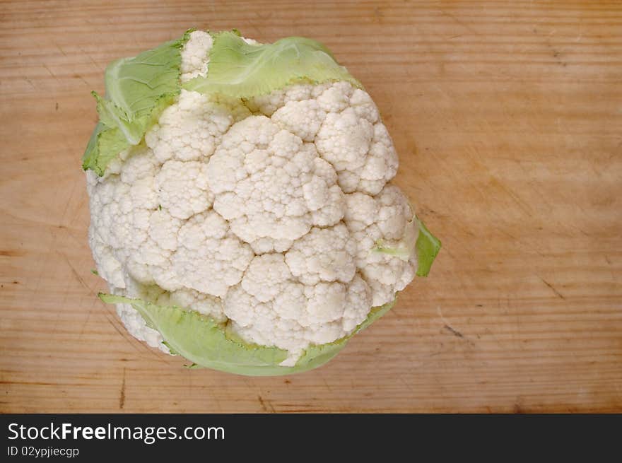 Fresh clean organic cauliflower head on table board