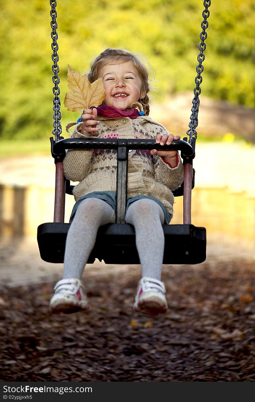 Little Happy Girl On The Swing