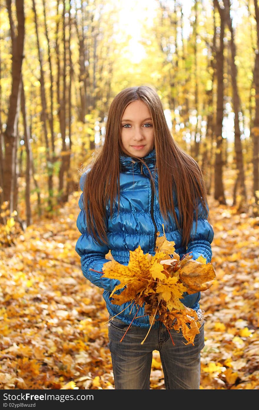 Young teenager girl in the autumn forest