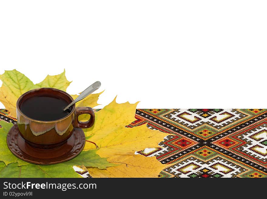 Still-life from a cup of tea and yellow autumn leaves