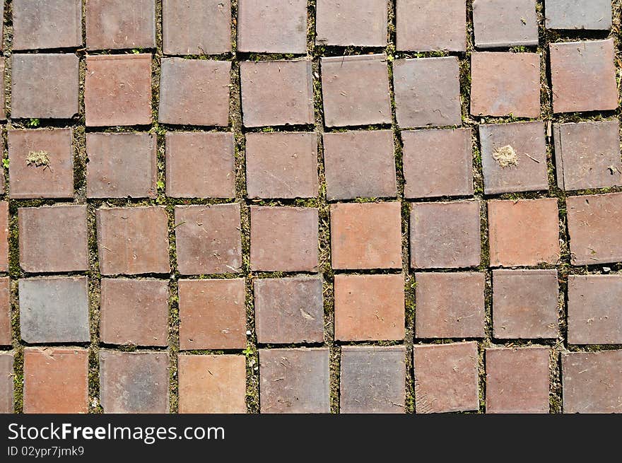 Closeup of square red clay brickwork. These bricks were originally on a walkway. Closeup of square red clay brickwork. These bricks were originally on a walkway.