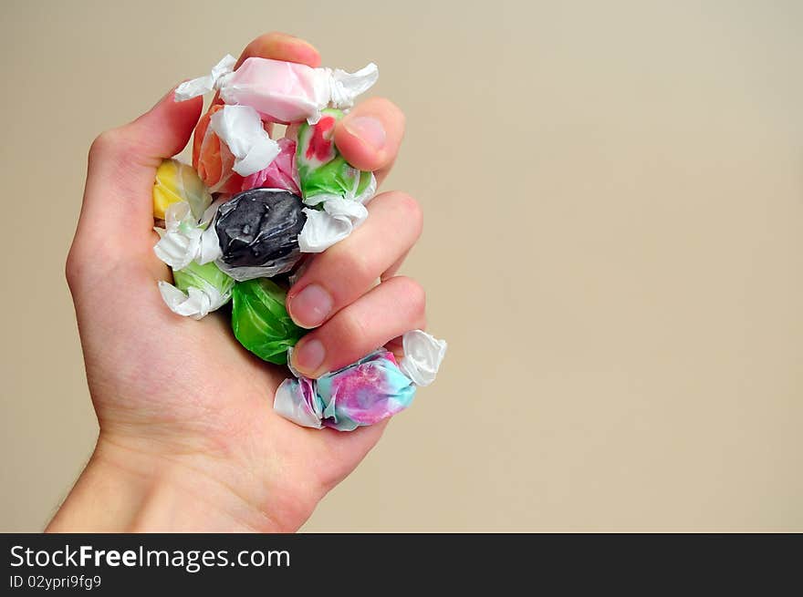 A pile of multicolored saltwater taffy candy on a white cloth.