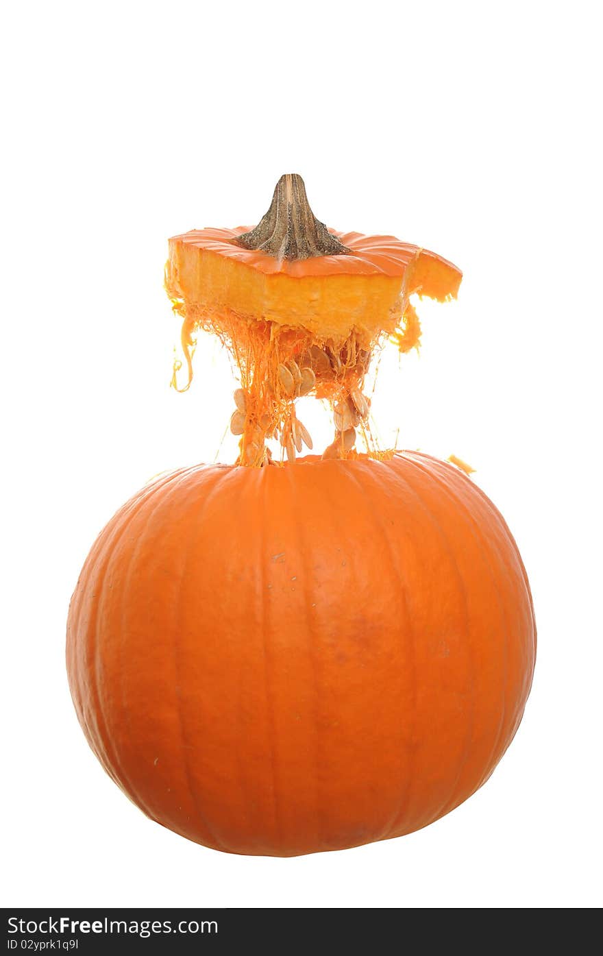 Orange pumpkin isolated on a white background with its top floating above it in mid air. Orange pumpkin isolated on a white background with its top floating above it in mid air.