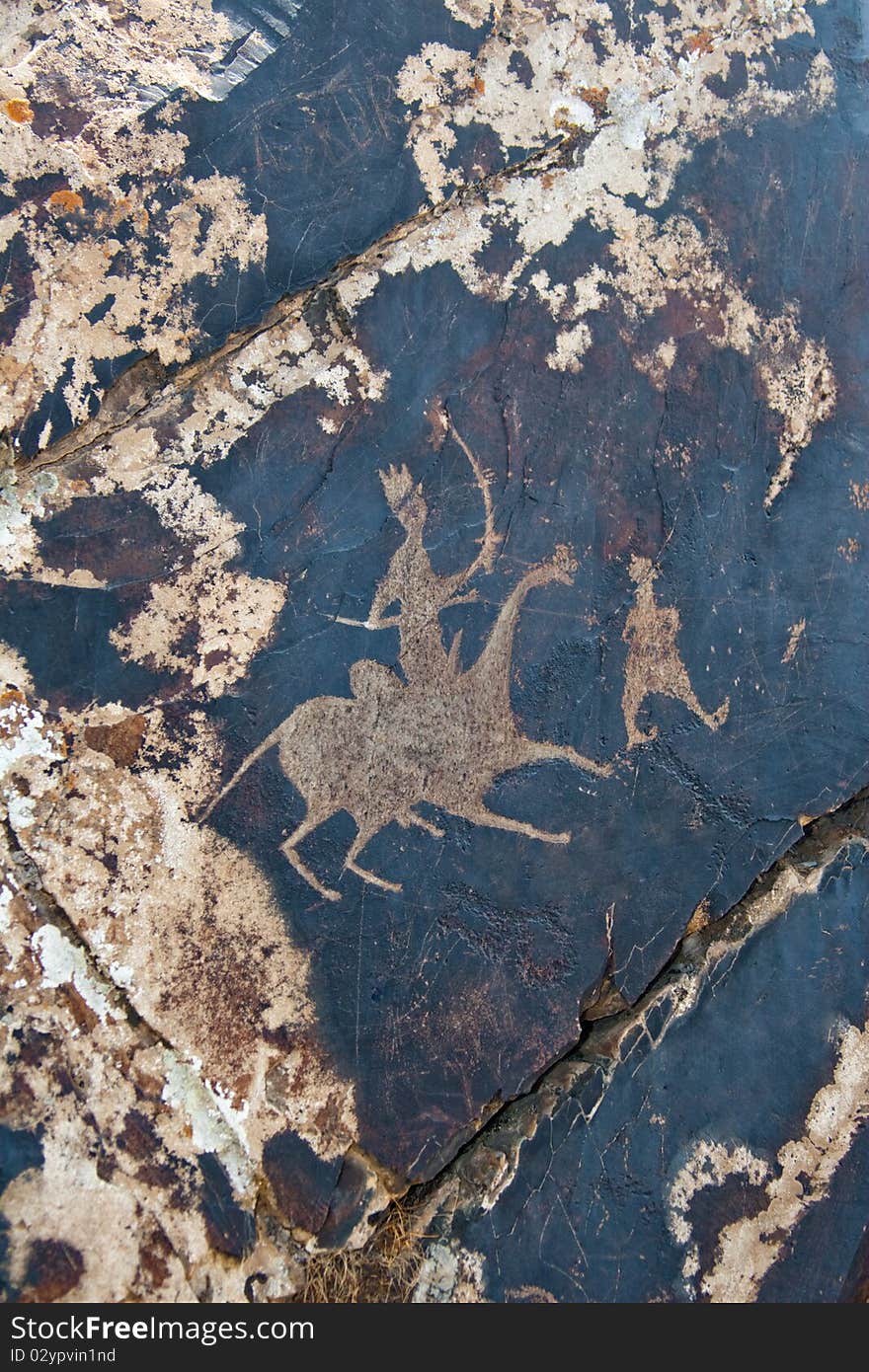 Petroglyph carved into rock surface by prehistoric asian nomads. Sarmishsay, Uzbekistan