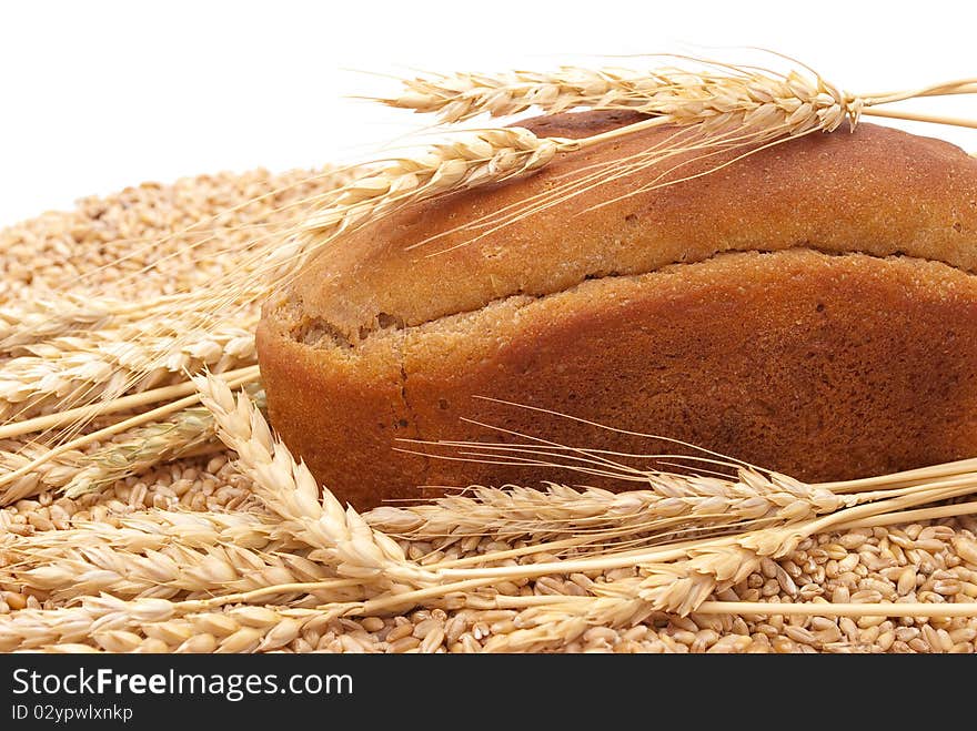 Bread with wheat and ears on white