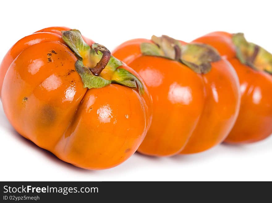 Ripe persimmons isolated on a white background