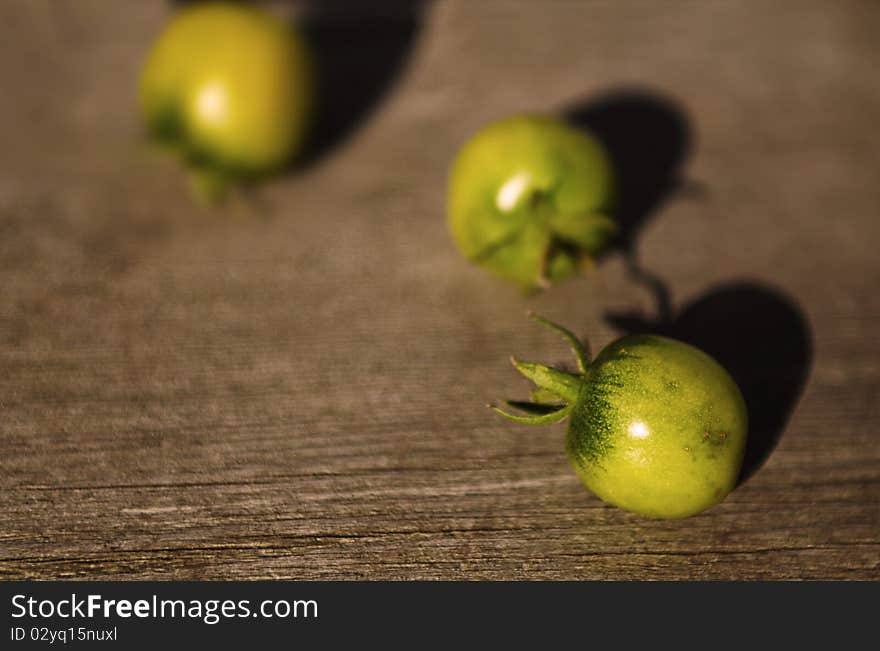 Three round fruit placed on wood texture. Three round fruit placed on wood texture