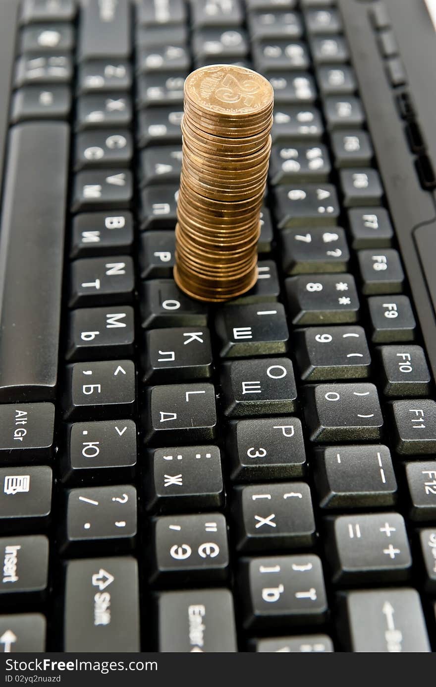 Coins on a black computer keyboard. Coins on a black computer keyboard