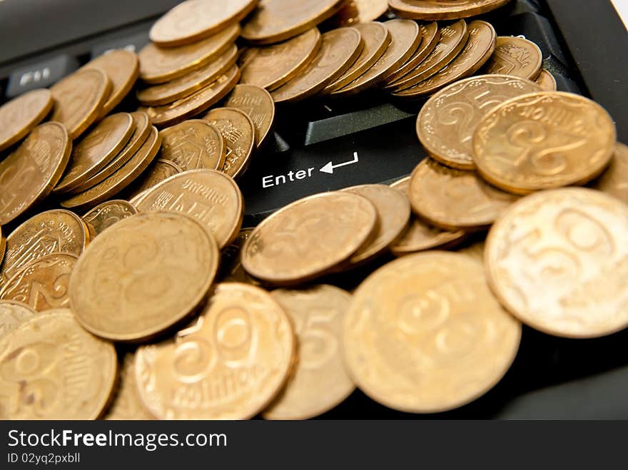 Heap of yellow coins on black keyboard. Heap of yellow coins on black keyboard