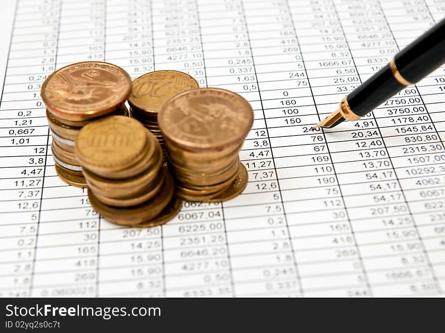 Financial document with numbers with coins stacks. Financial document with numbers with coins stacks