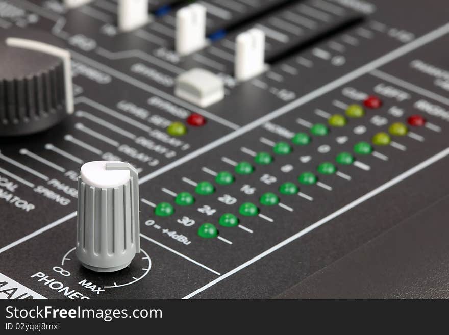 Closeup of audio mixing console. Shallow depth of field. Studio work.