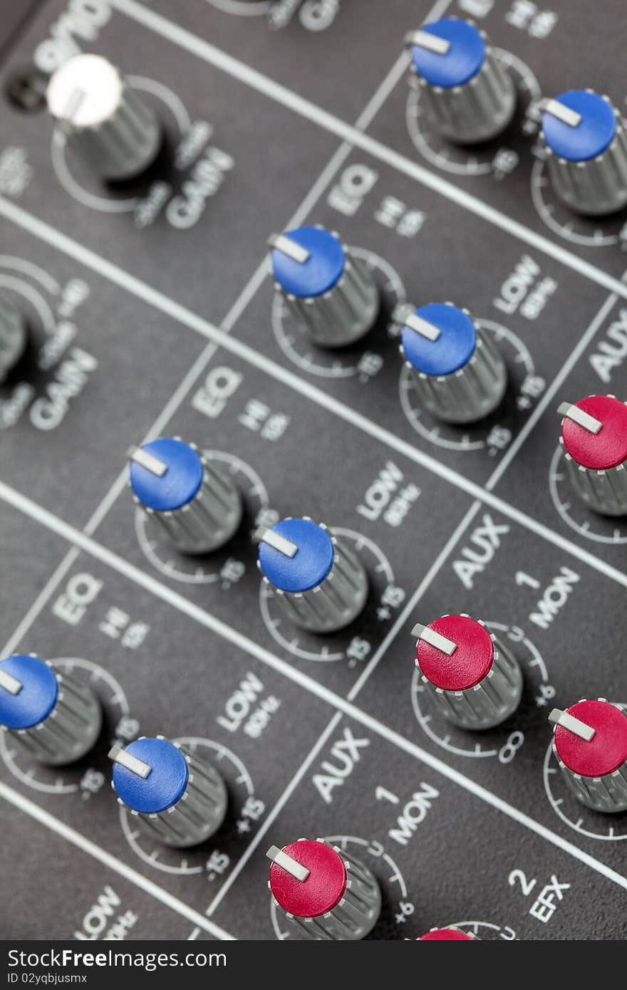 Closeup of audio mixing console. Shallow depth of field. Studio work.