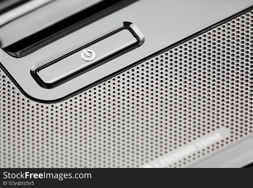 Closeup of laptop keyboard. Emphasis on On/Off button. Shallow depth of field. Studio work.