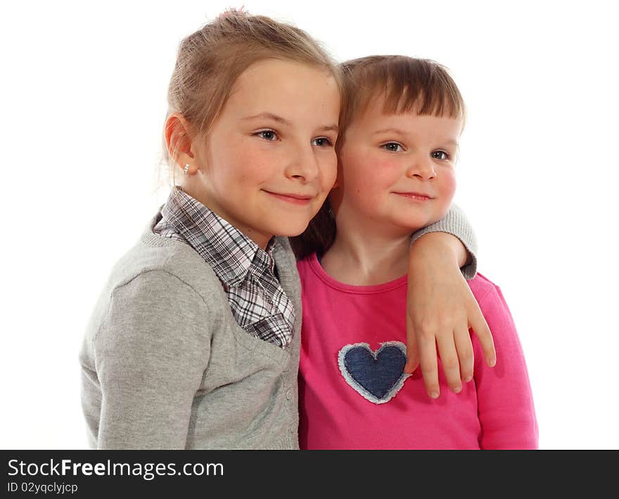 Two Young Sisters Posing Together In A Studio