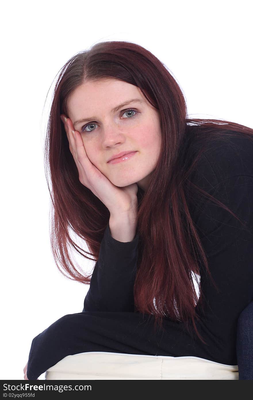 Young woman in studio resting chin on hand. Young woman in studio resting chin on hand