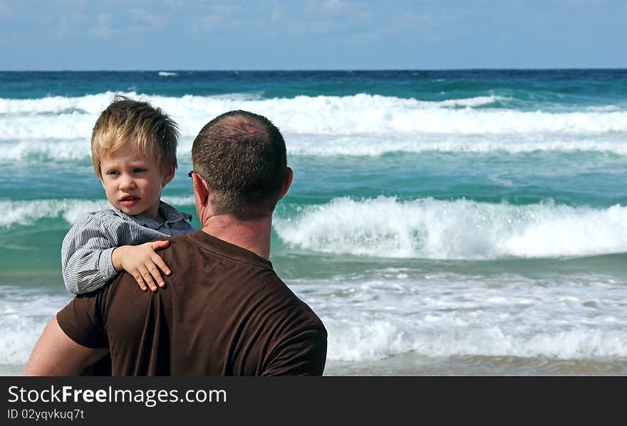 Father and son playing on a beach