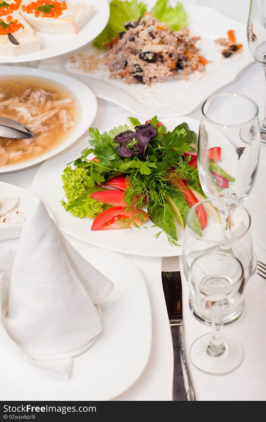 With several dishes on the white tablecloth. With several dishes on the white tablecloth