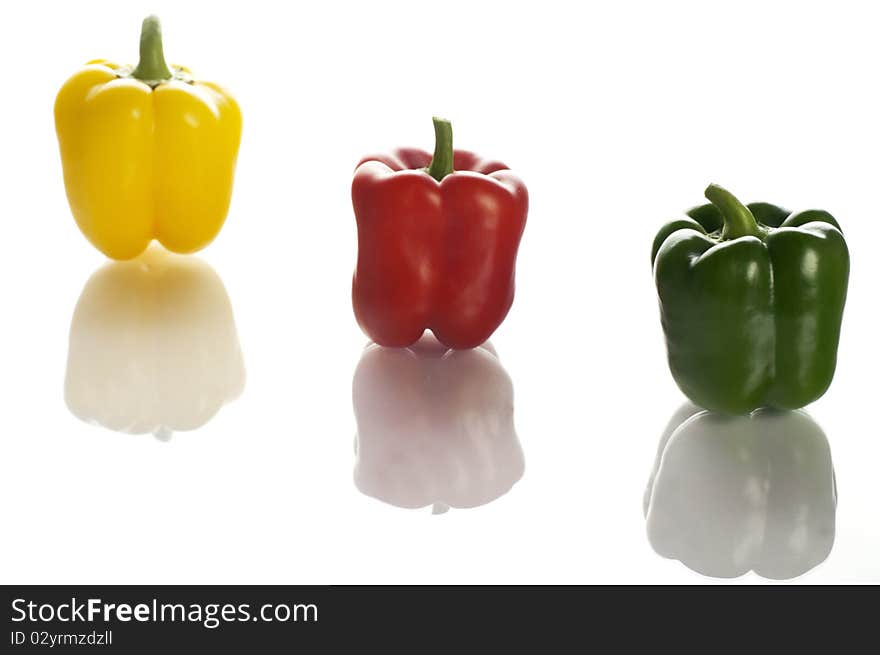 Three colourful peppers on the white background