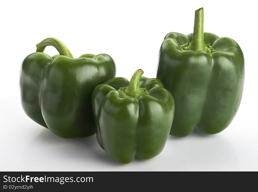 Three Green Fresh  Peppers On The White Background