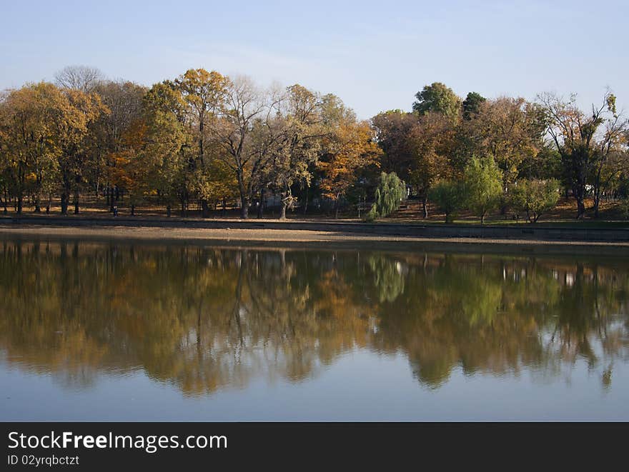 Autumn landscape with trees reflected in the lake. Autumn landscape with trees reflected in the lake