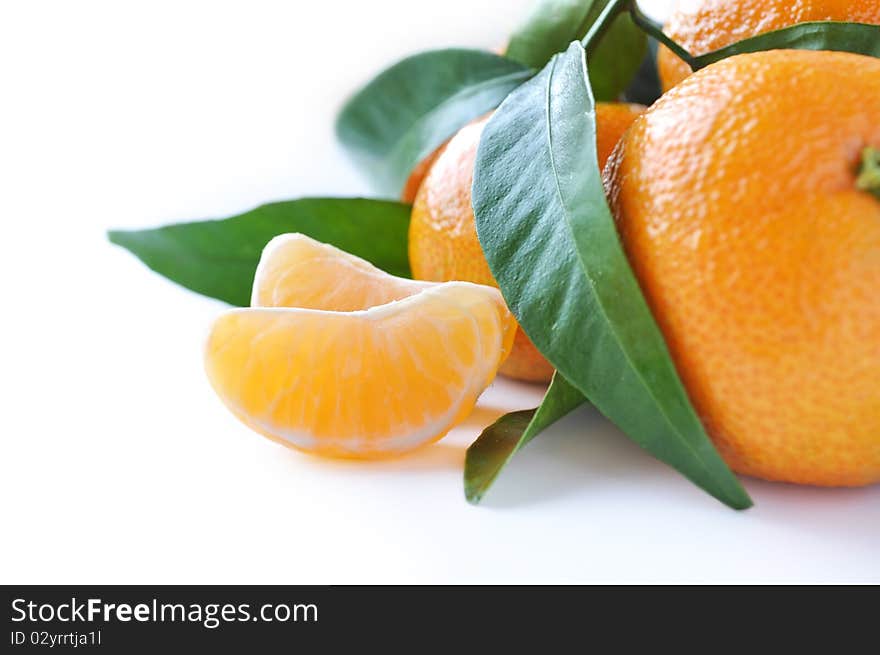 Juicy organic tangerines with leaves isolated on white background