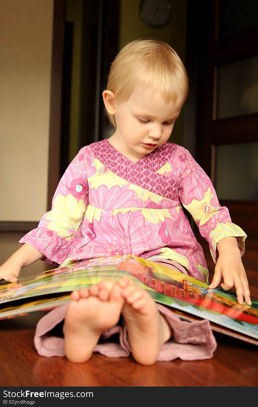 2 years old girl reading or browse through pop-up book. 2 years old girl reading or browse through pop-up book.