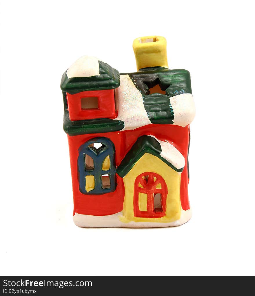 Ceramic candlestick a multi-colored small house with pipe and cheerful windows. Ceramic candlestick a multi-colored small house with pipe and cheerful windows