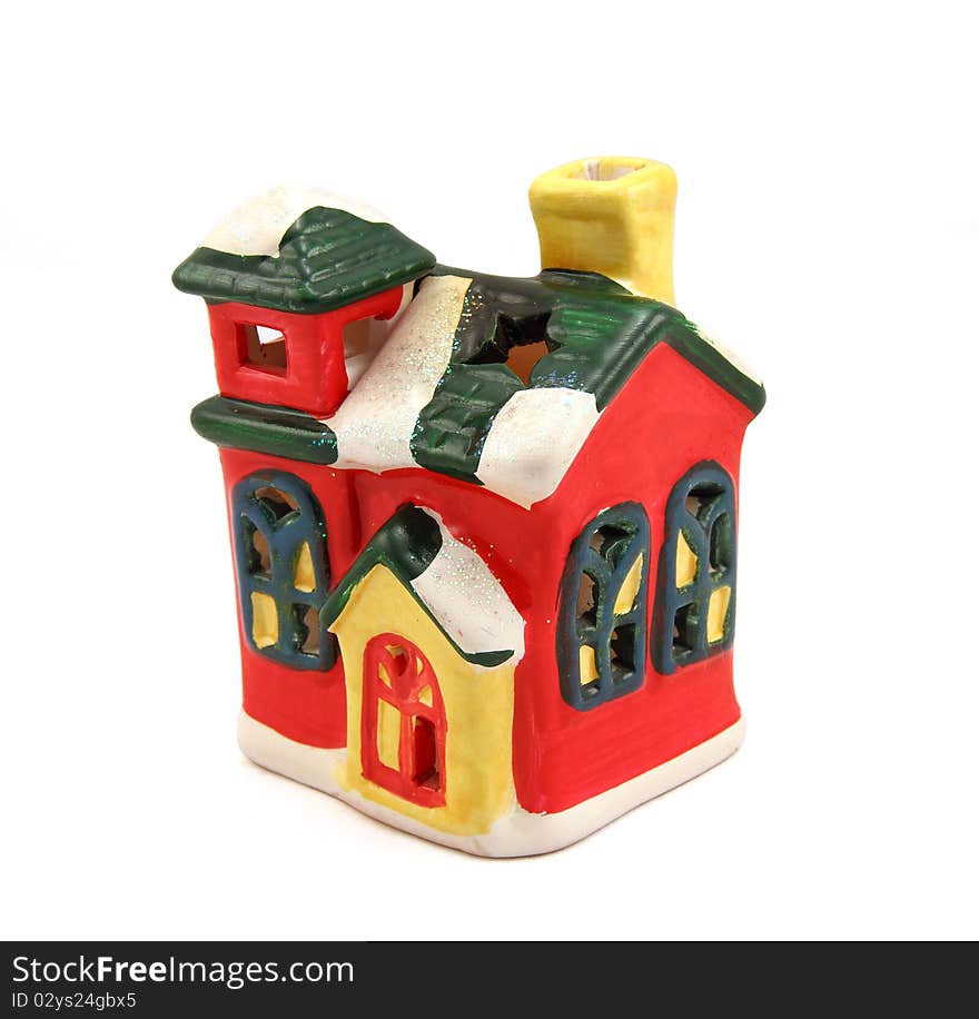 Ceramic candlestick a multi-colored small house with pipe and cheerful windows. Ceramic candlestick a multi-colored small house with pipe and cheerful windows