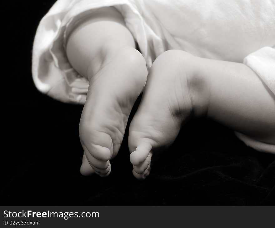 Two liitle foot on isolated black background. Two liitle foot on isolated black background