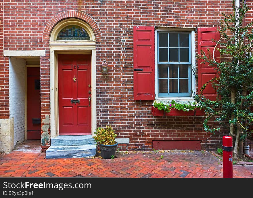 Colorful red door and brick wall