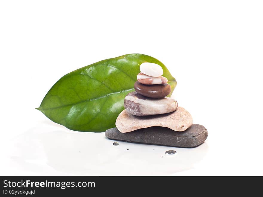 Green leaves and pyramid with stones. Green leaves and pyramid with stones