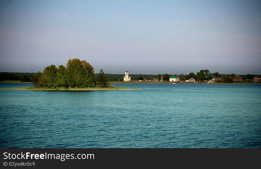 Beautiful tranquil landscape with old chapel on the horizon