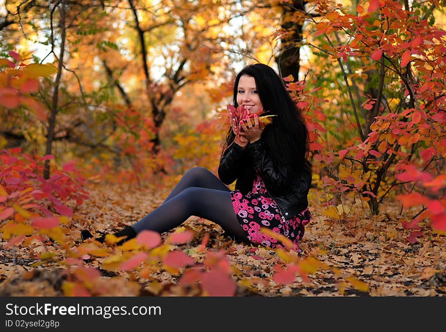 The girl brunette in autumn wood