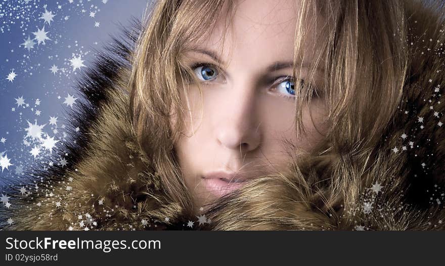 Beautiful girl in a winter fur collar