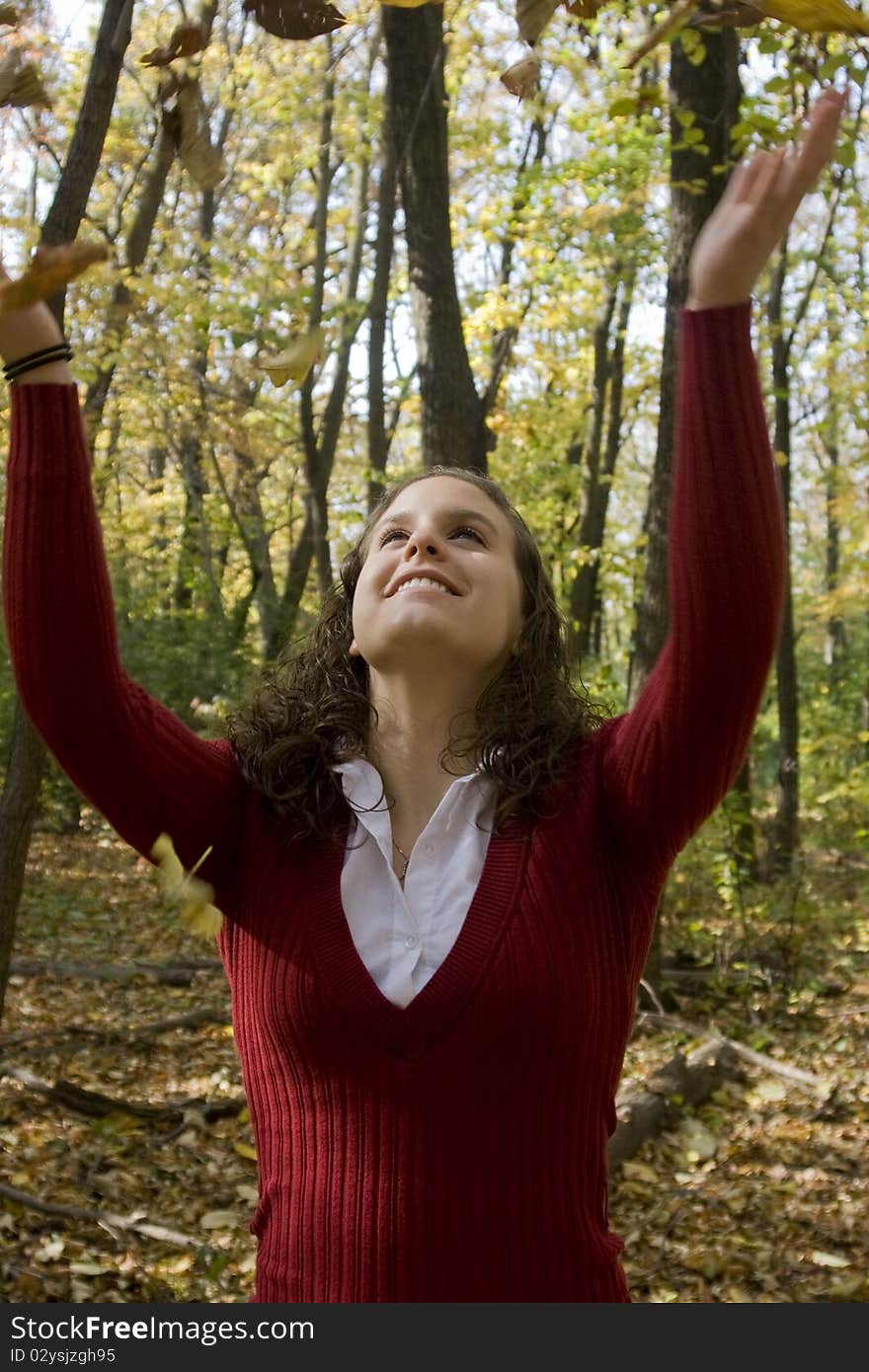 Young Woman Tossing Leaves