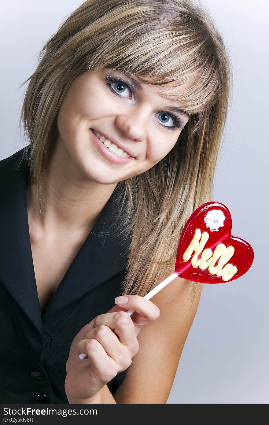 Portrait of an attractive girl with a lollipop