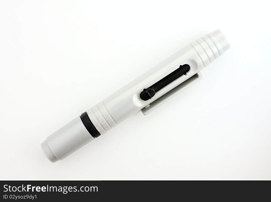 Lens pen for clean up your lens. On white paper. Lens pen for clean up your lens. On white paper.