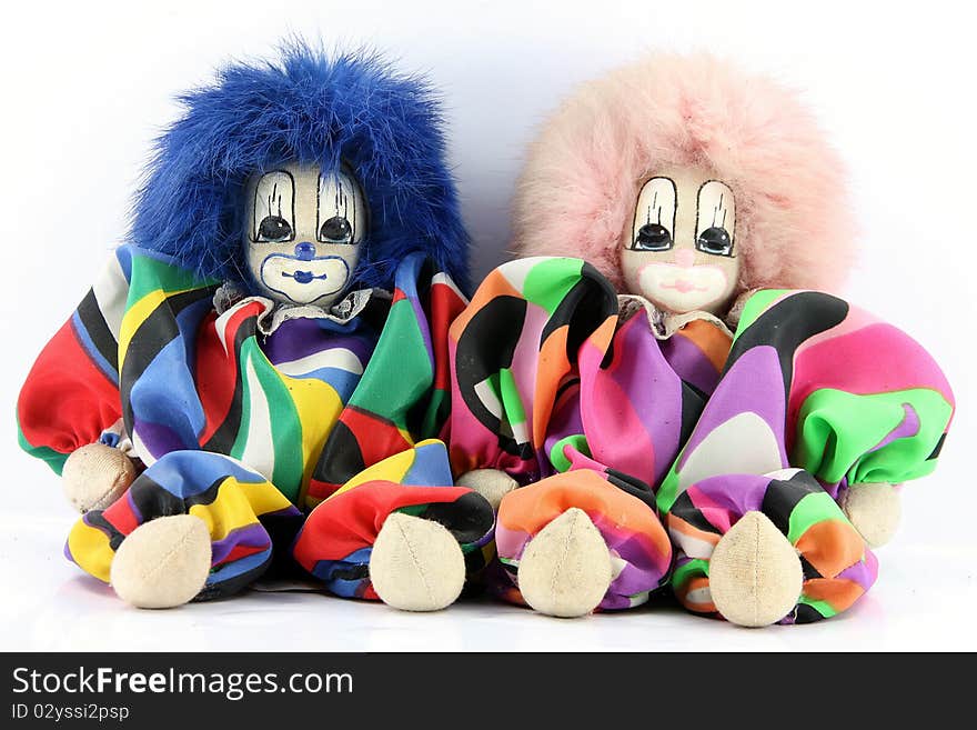 The Two Clown dolls sitting on a white background.