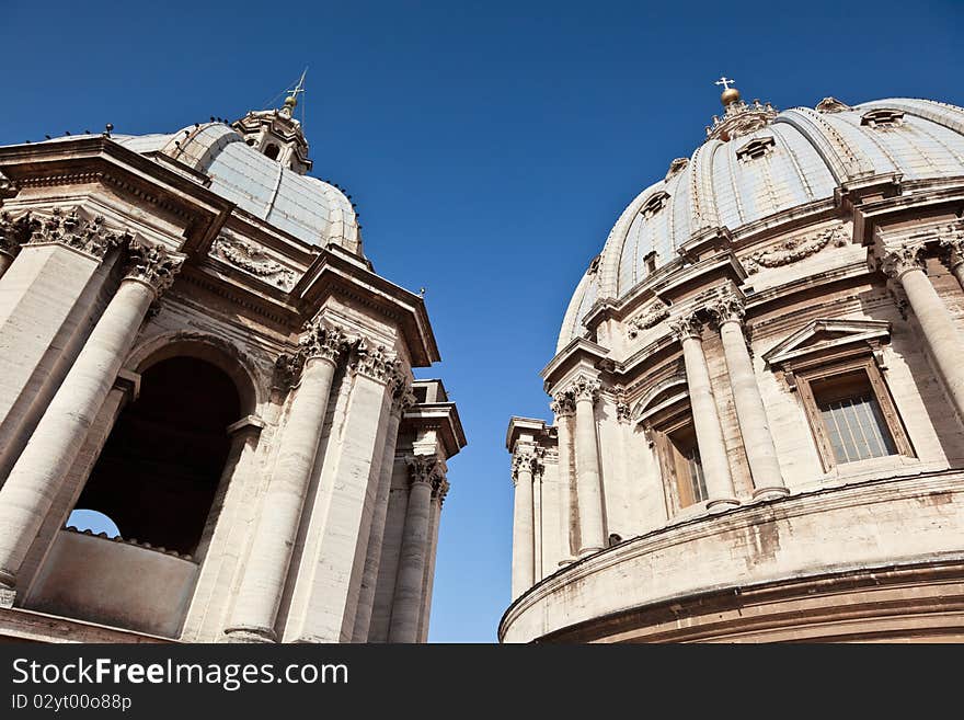 Exterior View of two, old church domes against a clear, blue sky.